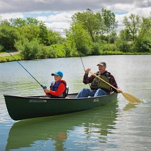 Man and child fishing in the Old Town Saranac 146 canoe