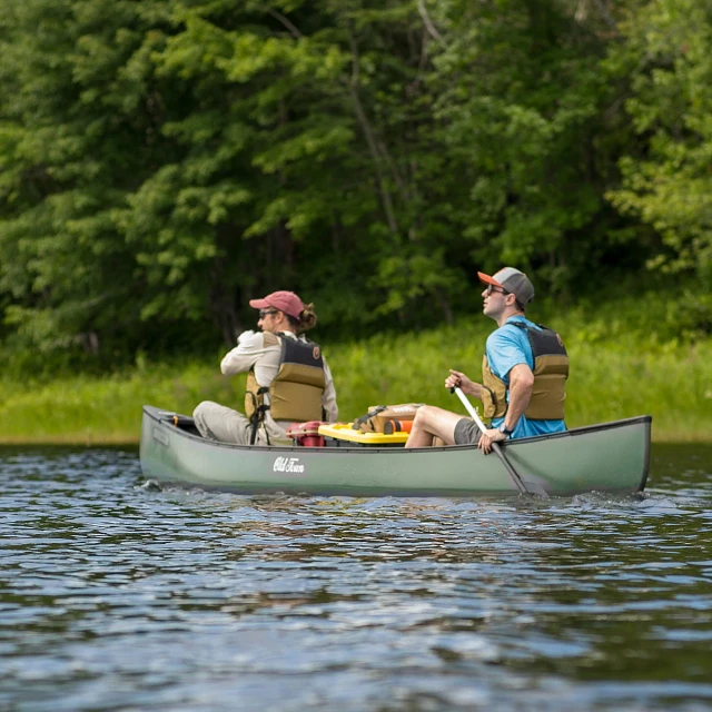 Two people paddling in the Old Town Discovery Canoe