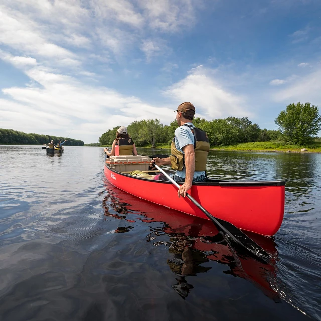 Two people paddling in the Old Town Discovery Canoe