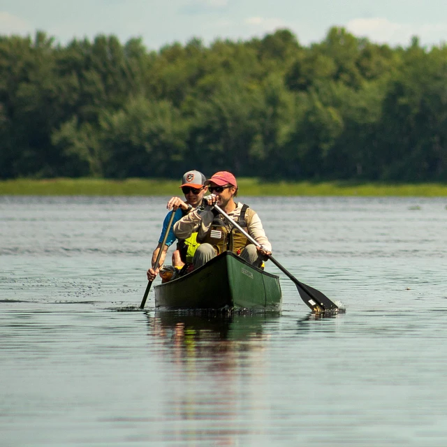 Two people paddling in the Old Town Discovery Canoe