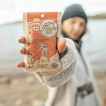 Closeup of Hikers Brew Red Rocks Coffee packet held by a woman