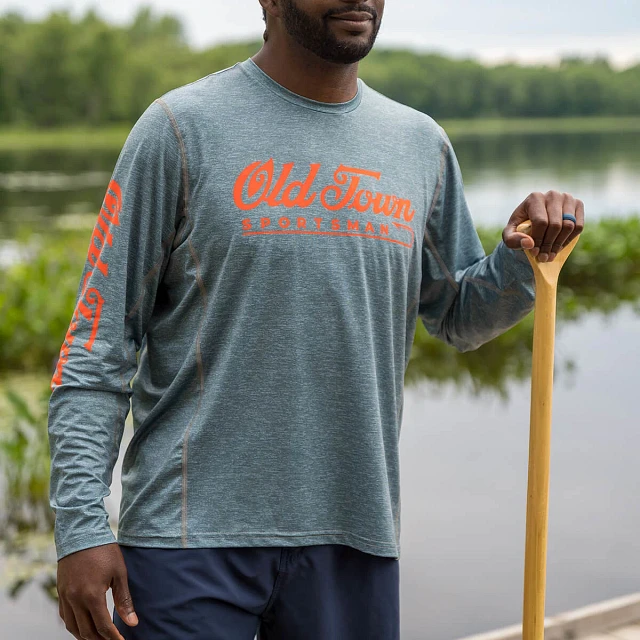 Man with paddle in hand wearing Old Town Sportsman LS Performance Hoodie