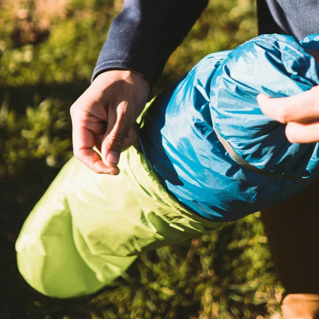 Person packing the Midori 2 tent