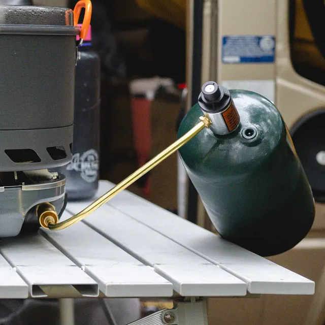 Genesis Fuel Regulator connected to Genesis Basecamp stove and hooked up to propane