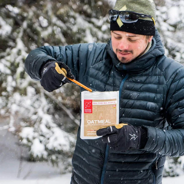 Man eating Good To-Go Oatmeal in the snow.