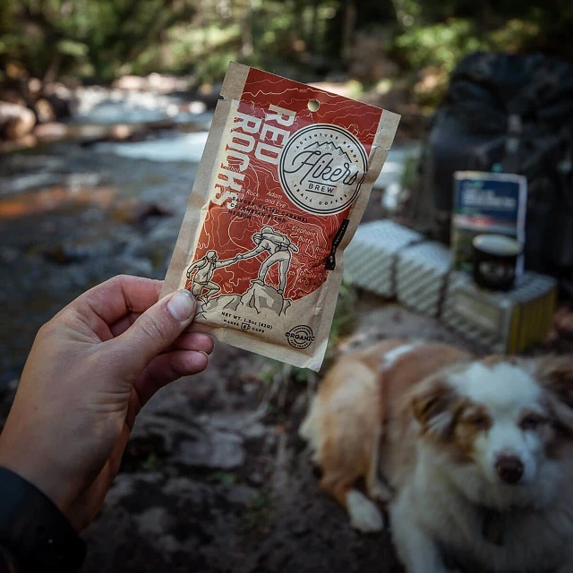 Close up of hand holding Hikers Brew Red Rocks trail coffee packet