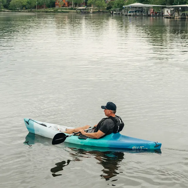 Man with Carlisle paddle relaxing in the Old Town Breeze kayak