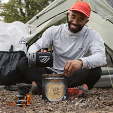 Pouring boiled water from Jetboil Zip 0.8L Fast Boil System into ready-to-go hiking meal