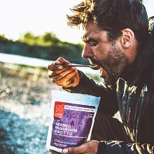 Man eating Good To-Go Herbed Mushroom Risotto meal