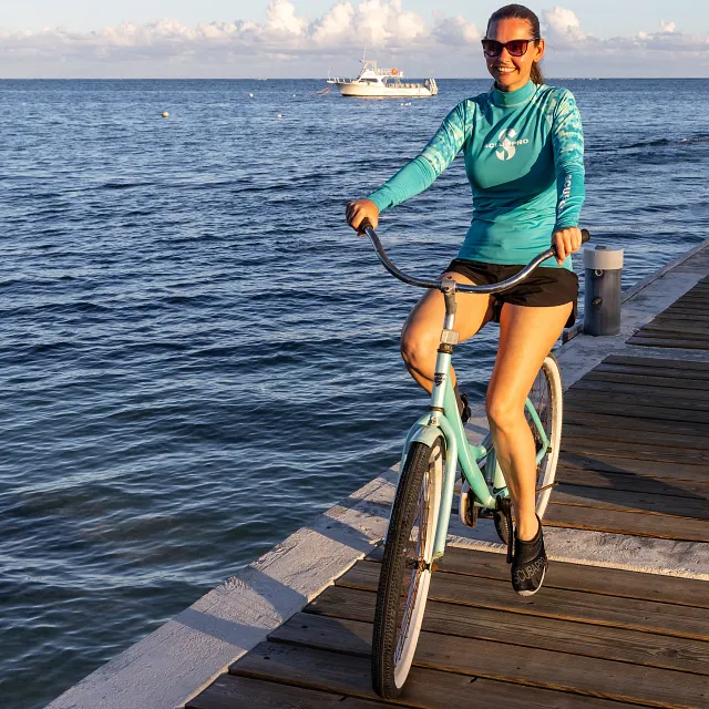 Kailua Beach Walker - Diver Riding Bike on Boardwalk