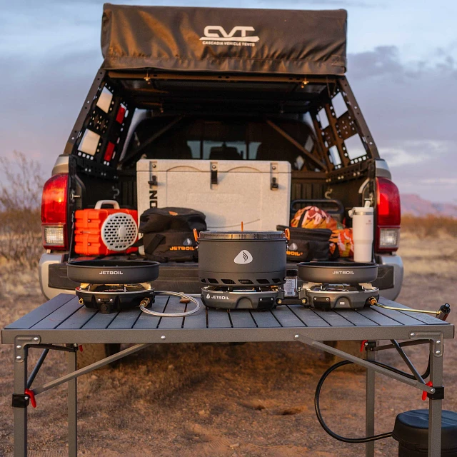 Genesis 3 Stove Bundle set up on camp table