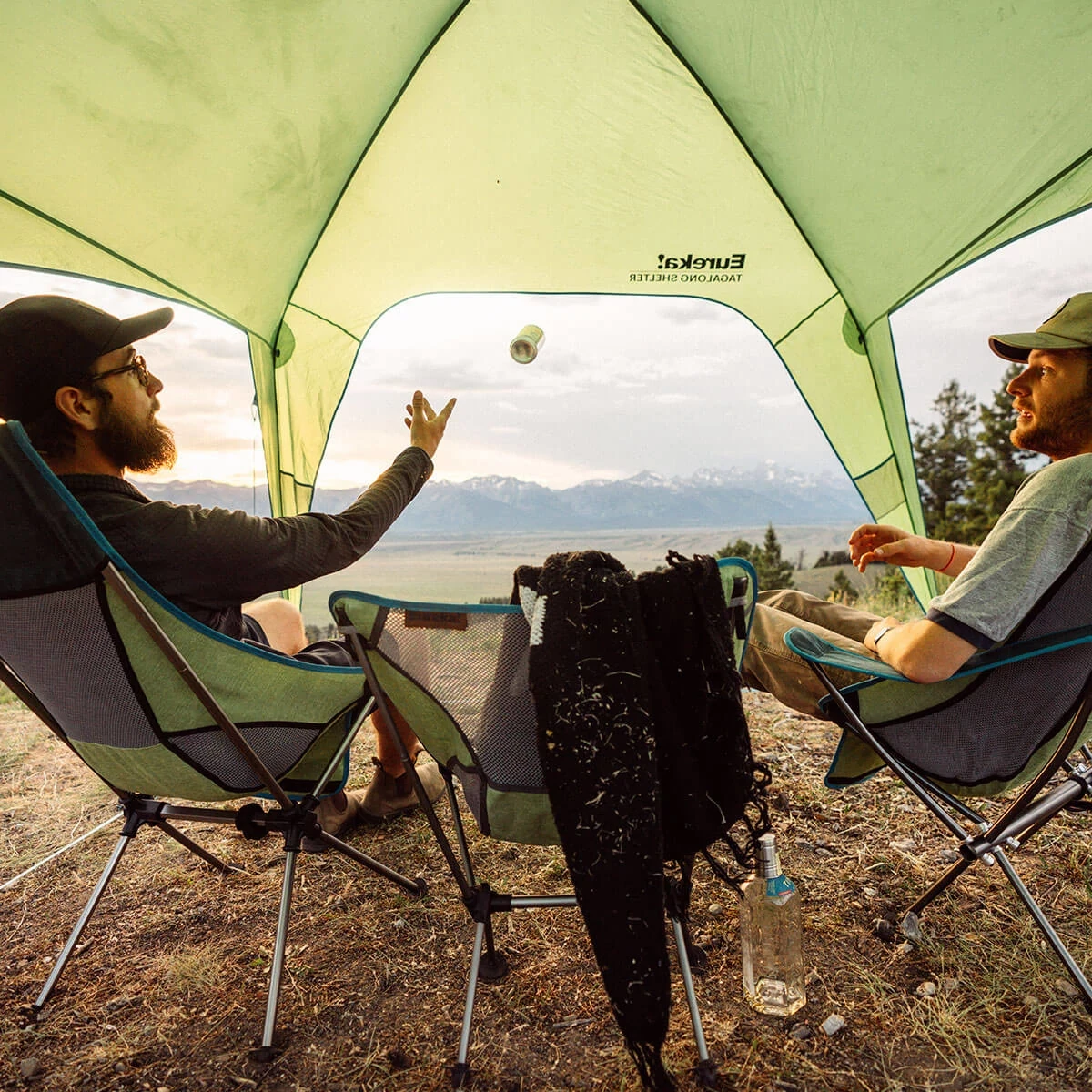 Two friends enjoying the Eureka! Tagalong Camp chairs underneath the Tagalong Shelter
