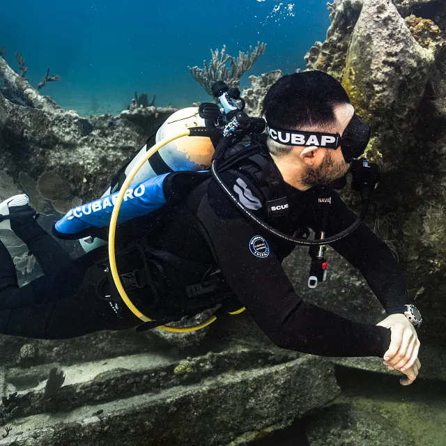 Diver using Navigator Lite Weight Pocket with Navigator Lite BCD underwater during reef dive