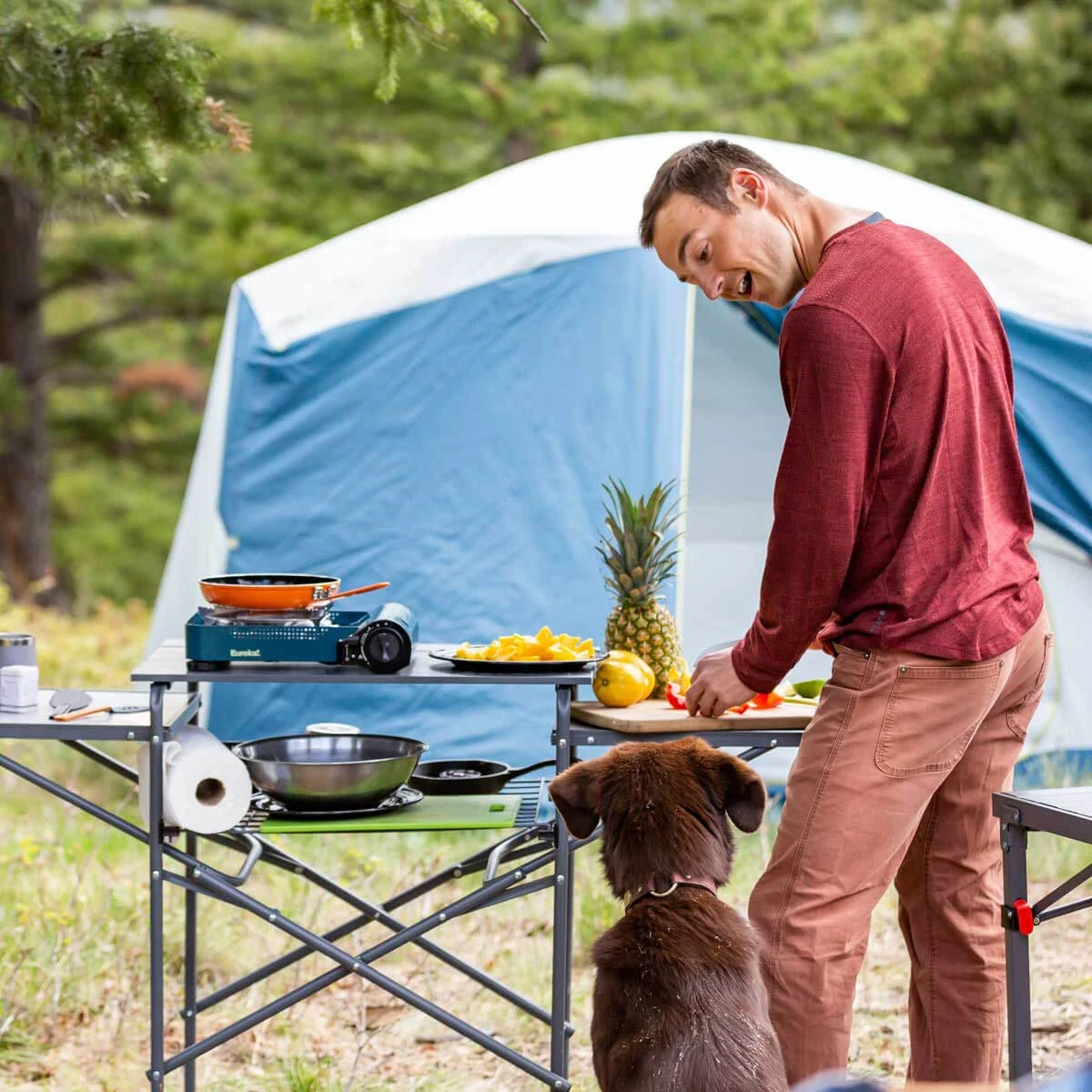 Man and dog in their camp kitchen