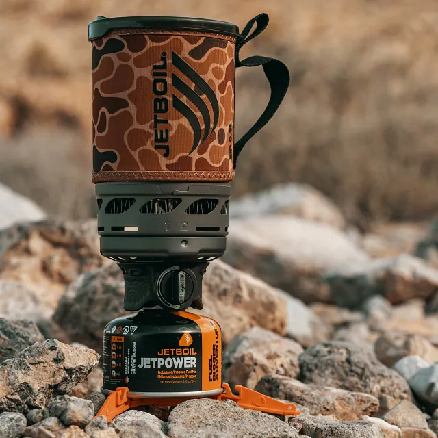 Fully assembled Jetboil Zip 0.8L Fast Boil System in Duck Camo out on a rocky trail