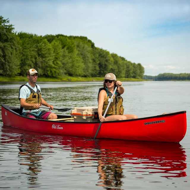 Two people paddling in the Old Town Discovery 158 canoe