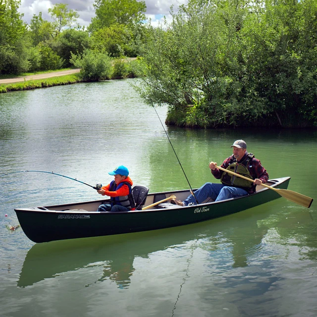 Man and child fishing in the Old Town Saranac 146 canoe