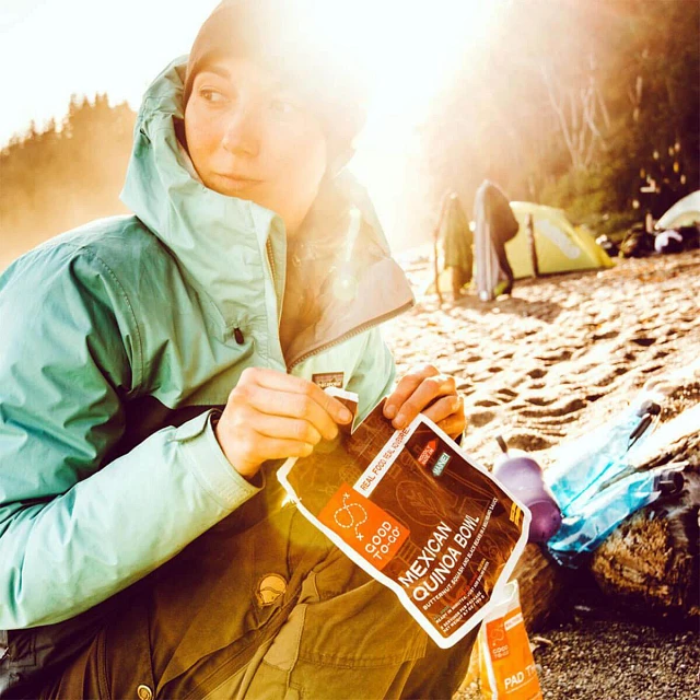 Woman on beach with Good To-Go meal