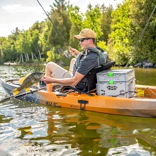 Holding caught fish in Old Town Sportsman 120 fishing kayak