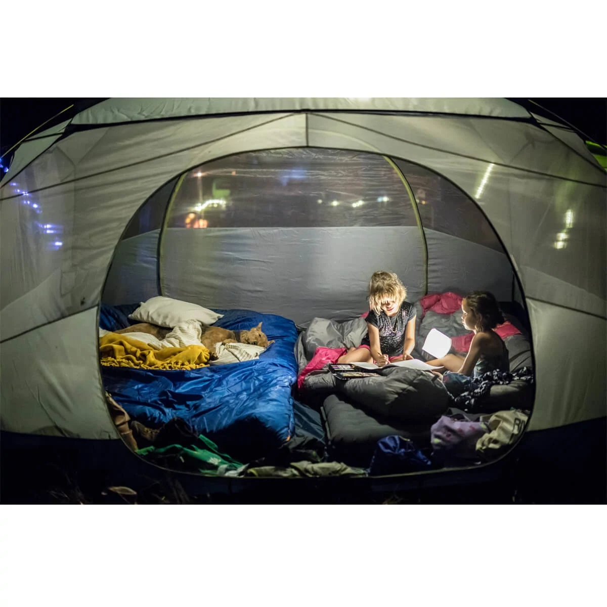 Kids inside a Space Camp 6 tent at night