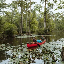 Two people paddling in the Old Town Discovery 169 canoe