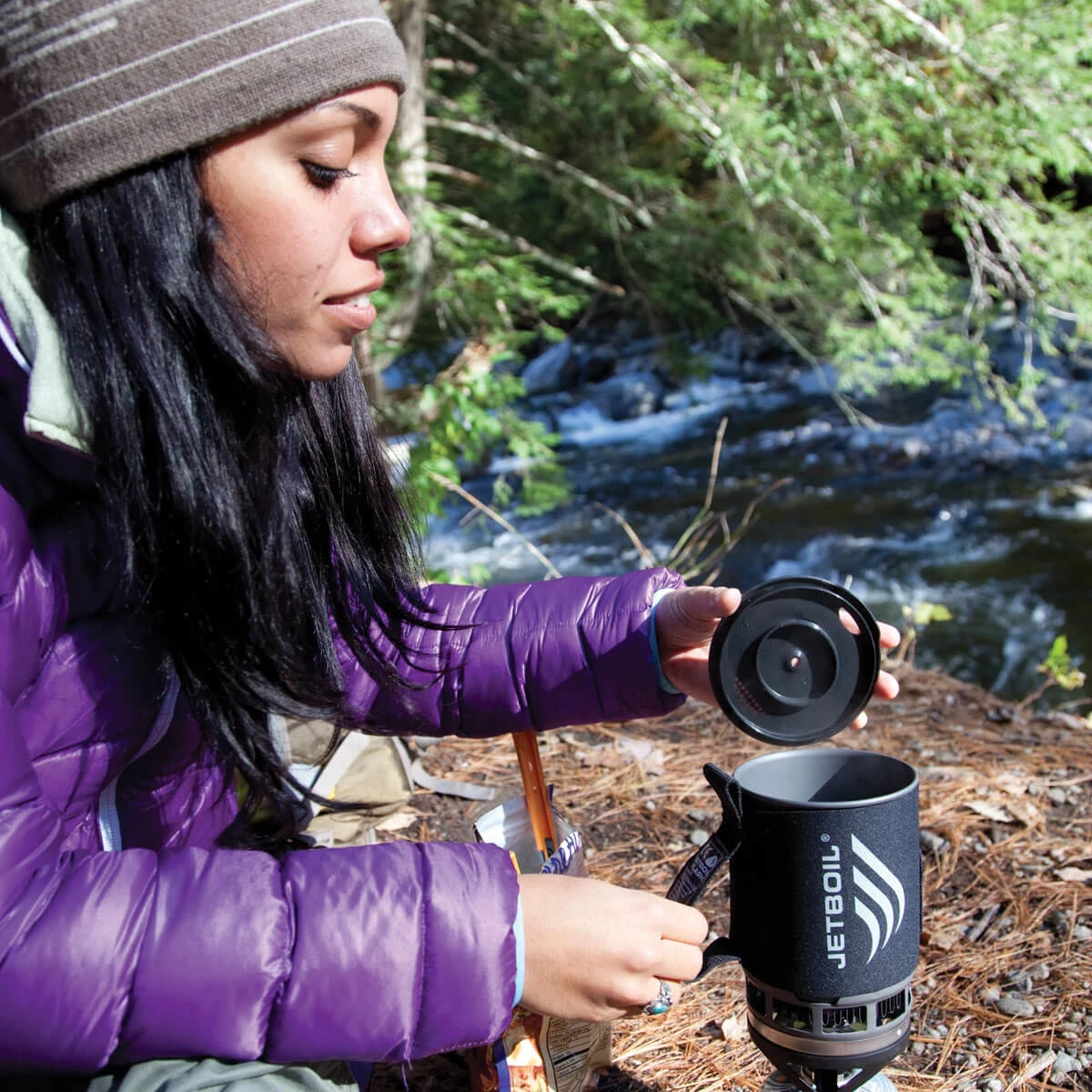 Woman using the Zip Cooking System on the trail