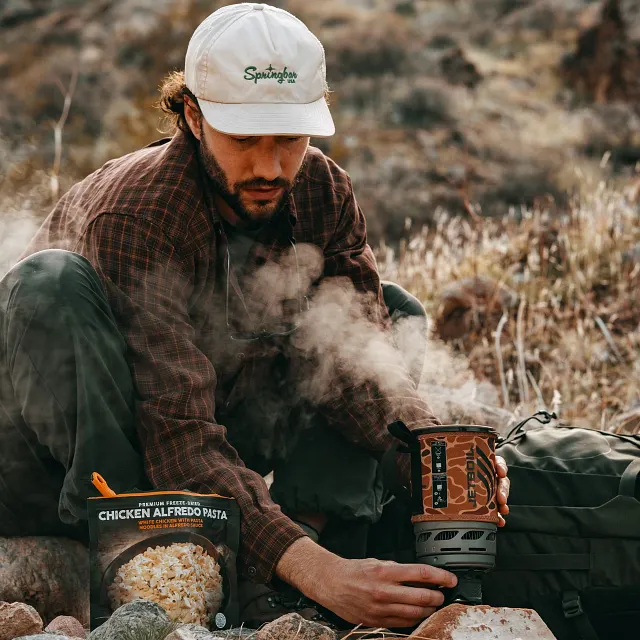 Rolling steam flowing out of the Jetboil Zip 0.8L Fast Boil System ready to be added to freeze dry meal out on the hiking trail