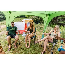 Campers sitting under Desert Canyon fly and frame used alone to create an open-walled sunshade