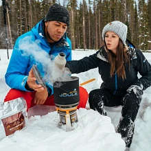Campers cooking with Joule Cooking System in snow