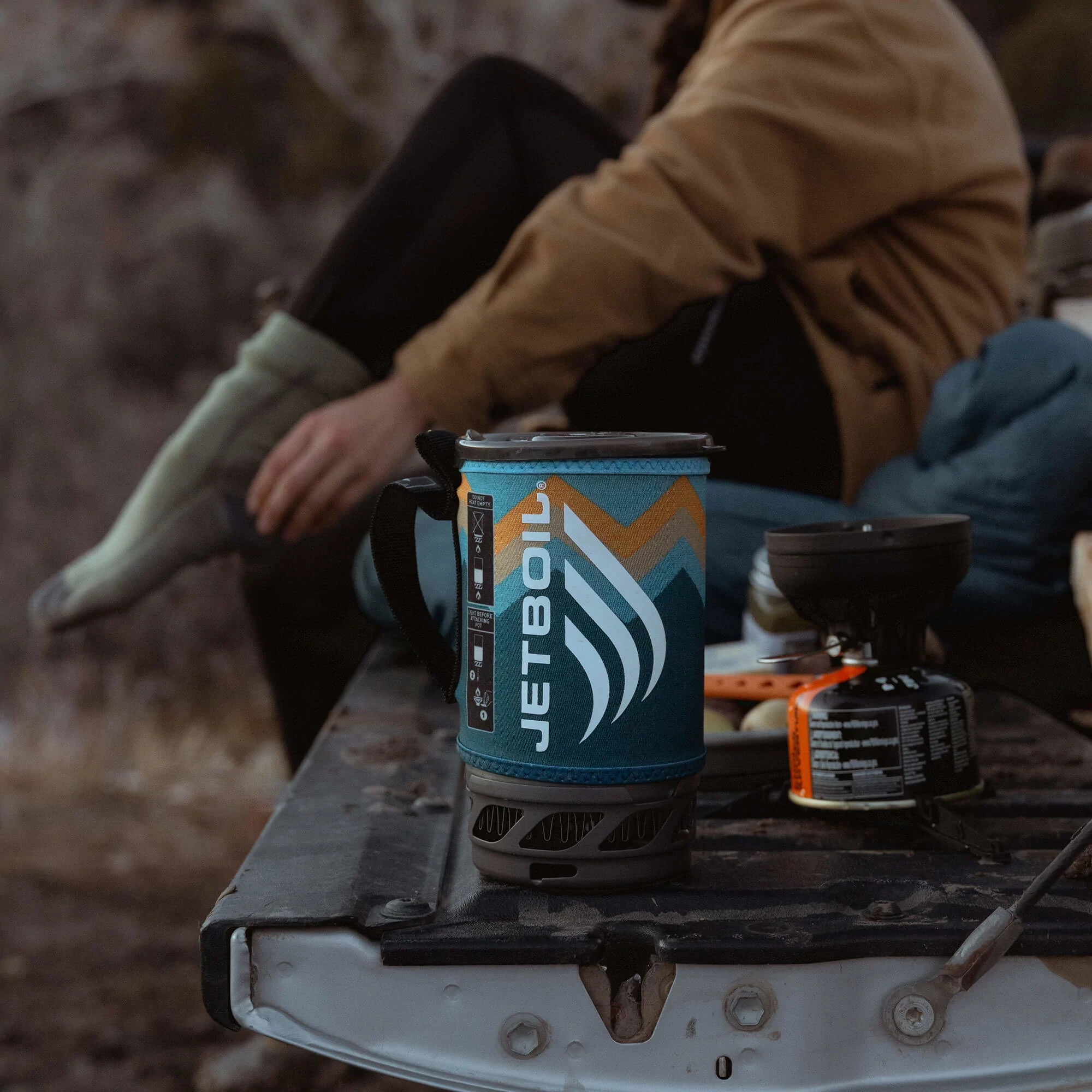 Packed Jetboil Flash Cooking System - Mountain Stripes next to burner and JetPower fuel