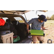 Man unpacking the Spire LX Camp Stove from the car