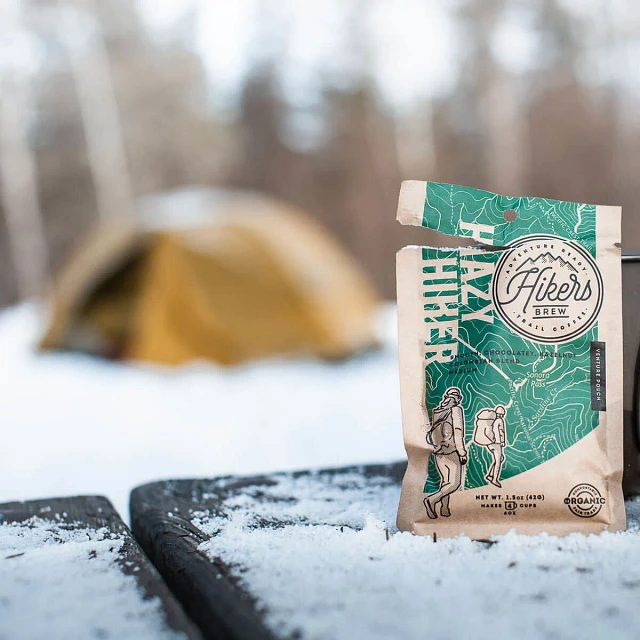 Closeup of Hikers Brew Hazy Hiker Trail Coffee packet with tent in background