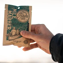 Close up of hand holding a Hikers Brew Mile Marker Coffee packet