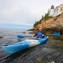 Man paddling on water in Old Town Loon 120 kayak in cloud