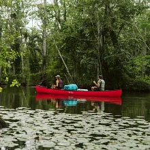 Two people looking at mountains while paddling in the Old Town Discovery 169 canoe